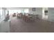 Large carpeted living and dining area with bright natural lighting and neutral decor at 100 Bluff View Dr # 401A, Belleair Bluffs, FL 33770