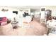 Expansive living space with abundant seating, TV, and comfortable rocking chairs at 100 Bluff View Dr # 401A, Belleair Bluffs, FL 33770