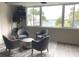 Inviting lounge area with cozy seating, a stylish rug, and a picturesque view of the water and palm trees at 100 Bluff View Dr # 401A, Belleair Bluffs, FL 33770