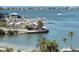 View of the marina with boat docks and a sandy beach area in the foreground, with waterfront homes in the distance at 100 Bluff View Dr # 401A, Belleair Bluffs, FL 33770