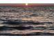 Orange sunset over dark ocean waves at 100 Bluff View Dr # 401A, Belleair Bluffs, FL 33770