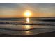 Tranquil sunset over ocean with sailboat, creating a picturesque coastal scene at 100 Bluff View Dr # 401A, Belleair Bluffs, FL 33770