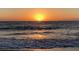 Picturesque golden sunset reflecting on ocean waves with calm water, creating a beautiful and peaceful beach view at 100 Bluff View Dr # 401A, Belleair Bluffs, FL 33770