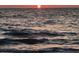 Breathtaking view of a sunset reflecting on calm ocean waves, creating a serene and peaceful coastal scene at 100 Bluff View Dr # 401A, Belleair Bluffs, FL 33770