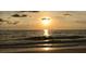 Picturesque ocean view displaying a bright sunset over calm waters under a cloudy sky at 100 Bluff View Dr # 401A, Belleair Bluffs, FL 33770