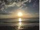 Gorgeous ocean view displaying a bright sunset under a cloudy sky at the beach at 100 Bluff View Dr # 401A, Belleair Bluffs, FL 33770