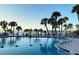 Inviting swimming pool with palm trees and lounge chairs, perfect for relaxation at 100 Bluff View Dr # 401A, Belleair Bluffs, FL 33770