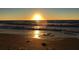 Beautiful beach sunset at twilight reflects the sky in the ocean with footprints in the sand at 100 Bluff View Dr # 401A, Belleair Bluffs, FL 33770