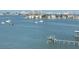 Expansive waterfront view featuring calm waters, boats, and a dock, complemented by a backdrop of city skyline at 100 Bluff View Dr # 401A, Belleair Bluffs, FL 33770