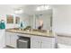 Well-lit bathroom featuring a double sink vanity with granite counters and a large mirror at 10144 Arbor Run Dr # 107, Tampa, FL 33647