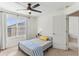 Cozy bedroom with natural light, ceiling fan, and neutral decor at 10144 Arbor Run Dr # 107, Tampa, FL 33647