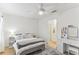 Bright bedroom features a ceiling fan, ensuite bath, and a vanity with abundant storage at 10144 Arbor Run Dr # 107, Tampa, FL 33647