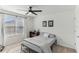 Bedroom features a window and furniture with neutral-colored walls and a ceiling fan at 10144 Arbor Run Dr # 107, Tampa, FL 33647