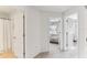 Hallway with views to a bedroom and bathroom; featuring neutral paint and carpeted floors at 10144 Arbor Run Dr # 107, Tampa, FL 33647