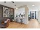 Open concept view from living room to kitchen featuring a breakfast bar and stainless steel appliances at 10144 Arbor Run Dr # 107, Tampa, FL 33647