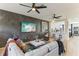 Open-concept living room with kitchen view, modern decor, accent wall, and stylish furniture at 10144 Arbor Run Dr # 107, Tampa, FL 33647