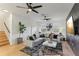Living room featuring an L-shaped sofa, large windows, stylish decor, and neutral color palette at 10144 Arbor Run Dr # 107, Tampa, FL 33647