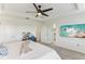 Bright main bedroom with a ceiling fan, neutral decor, and a doorway leading to the bathroom at 10144 Arbor Run Dr # 107, Tampa, FL 33647