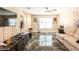 Spacious living room with marble floors, large TV, and guitar at 10428 Rivercrest Dr, Riverview, FL 33578