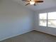 Bright bedroom with large window and ceiling fan at 11016 Holly Cone Dr, Riverview, FL 33569