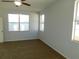 Bright bedroom featuring two windows and ceiling fan at 11016 Holly Cone Dr, Riverview, FL 33569