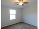 Simple bedroom with large window and ceiling fan at 11016 Holly Cone Dr, Riverview, FL 33569