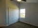 Well-lit bedroom with double-door closet and window at 11016 Holly Cone Dr, Riverview, FL 33569