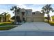 Two-story house with a three-car garage and landscaped front yard at 11016 Holly Cone Dr, Riverview, FL 33569