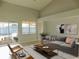 Living room with gray couch and access to the pool area at 11016 Holly Cone Dr, Riverview, FL 33569