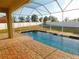 Screened-in pool with brick pavers and fenced yard at 11016 Holly Cone Dr, Riverview, FL 33569