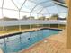 Screened-in pool with brick pavers and fenced yard at 11016 Holly Cone Dr, Riverview, FL 33569