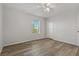 Bright bedroom with wood-look floors, ceiling fan, and window at 11080 Winter Crest Dr, Riverview, FL 33569