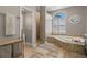 Spa-like bathroom with soaking tub, separate shower, and ample counter space at 1257 Kings Way Ln, Tarpon Springs, FL 34688