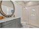 Bathroom with grey vanity, marble countertop and large shower at 1257 Kings Way Ln, Tarpon Springs, FL 34688