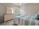 Bright bedroom with a dresser and striped bedding at 1257 Kings Way Ln, Tarpon Springs, FL 34688