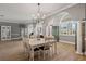 Formal dining room with hardwood floors, white table, and chandelier at 1257 Kings Way Ln, Tarpon Springs, FL 34688