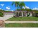 Stunning house exterior with a three-car garage at 1257 Kings Way Ln, Tarpon Springs, FL 34688