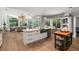 Open kitchen with large island, hardwood floors and views to Gathering room at 1257 Kings Way Ln, Tarpon Springs, FL 34688