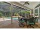Covered lanai with pool and outdoor dining furniture at 1257 Kings Way Ln, Tarpon Springs, FL 34688