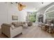 Light and airy living room with hardwood floors and comfortable seating at 1257 Kings Way Ln, Tarpon Springs, FL 34688