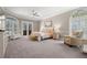 Spacious main bedroom with plush carpeting, lots of natural light and a sitting area at 1257 Kings Way Ln, Tarpon Springs, FL 34688