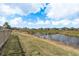 Backyard view of a pond and neighborhood homes at 13387 Crest Lake Dr, Hudson, FL 34669