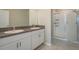 Bright bathroom with double sink vanity, granite countertop and a glass shower enclosure at 13387 Crest Lake Dr, Hudson, FL 34669