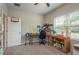 This bedroom features a desk, window, and fan at 13387 Crest Lake Dr, Hudson, FL 34669