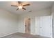Cozy bedroom with ceiling fan, carpeted floor, and an ensuite bathroom with closet access at 13387 Crest Lake Dr, Hudson, FL 34669