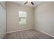 This bedroom features a window, fan, and carpet at 13387 Crest Lake Dr, Hudson, FL 34669