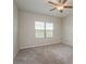 Simple bedroom with carpet, ceiling fan, and a window bringing in natural light at 13387 Crest Lake Dr, Hudson, FL 34669