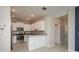 Bright kitchen featuring white cabinets, stainless steel appliances, and granite countertops, with bar seating at 13387 Crest Lake Dr, Hudson, FL 34669
