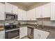 Updated kitchen with granite counters, stainless steel appliances and bright white cabinets at 13387 Crest Lake Dr, Hudson, FL 34669