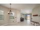 Bright living room featuring a modern chandelier and sliding glass doors leading to an outdoor patio at 13387 Crest Lake Dr, Hudson, FL 34669